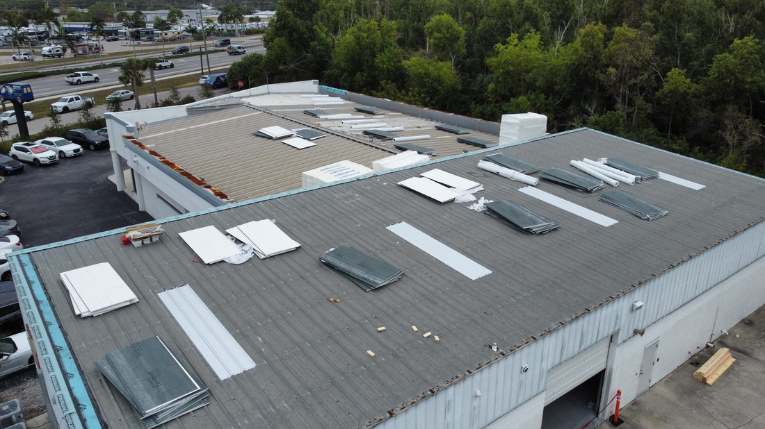Roofing materials staged across a commercial roof