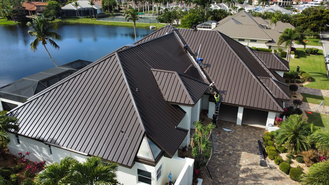 Dark metal roof on a home beside a lake